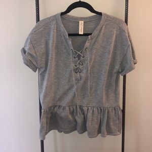 Grey peplum lace up top